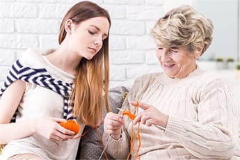 Girl crocheting with grandmother